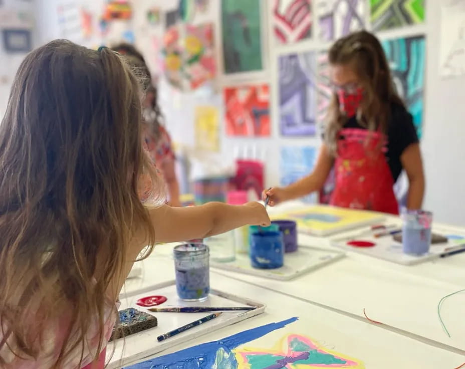 a girl painting on a table