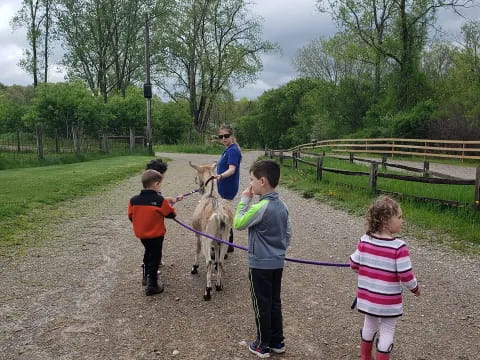 a group of kids holding a dog