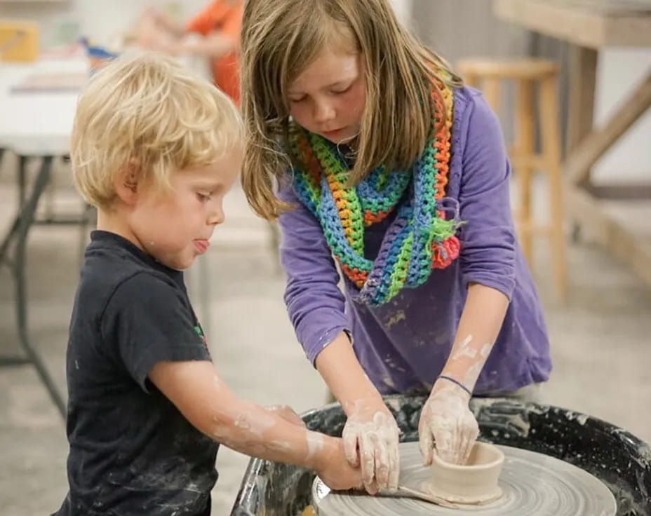 a person and a boy making a cake