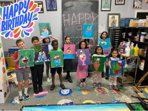 a group of children holding up colorful signs in a classroom