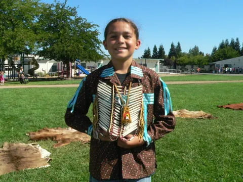 a boy holding a large instrument