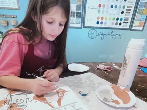 a girl painting on a table