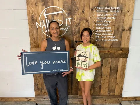two girls holding signs