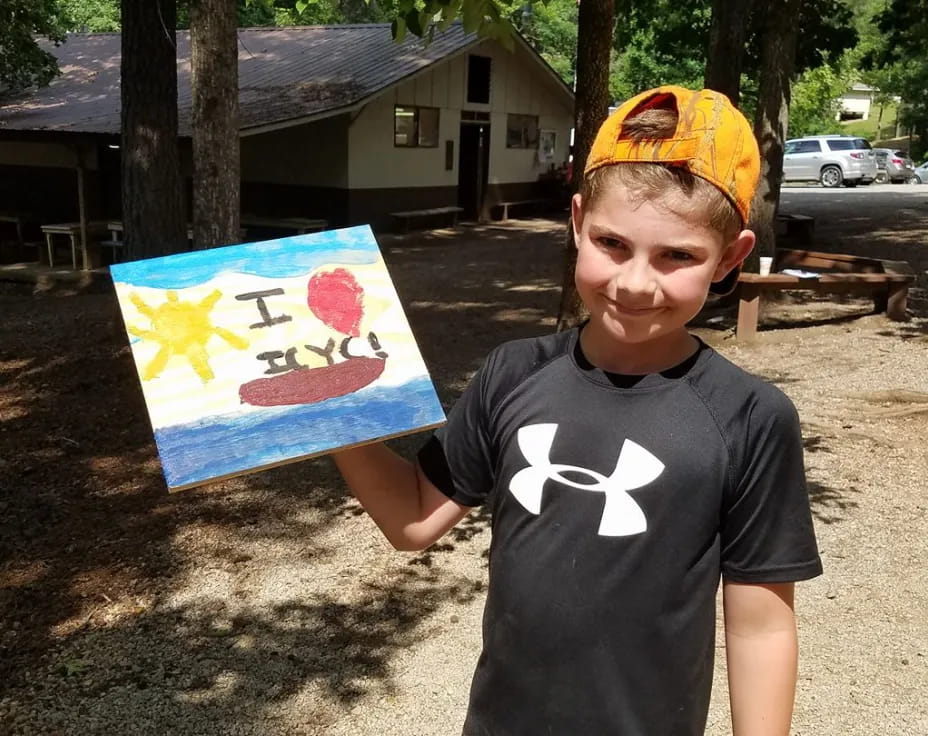 a boy holding a painting