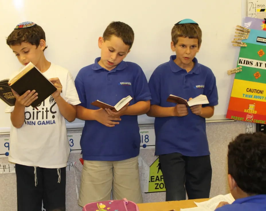 a group of kids holding books