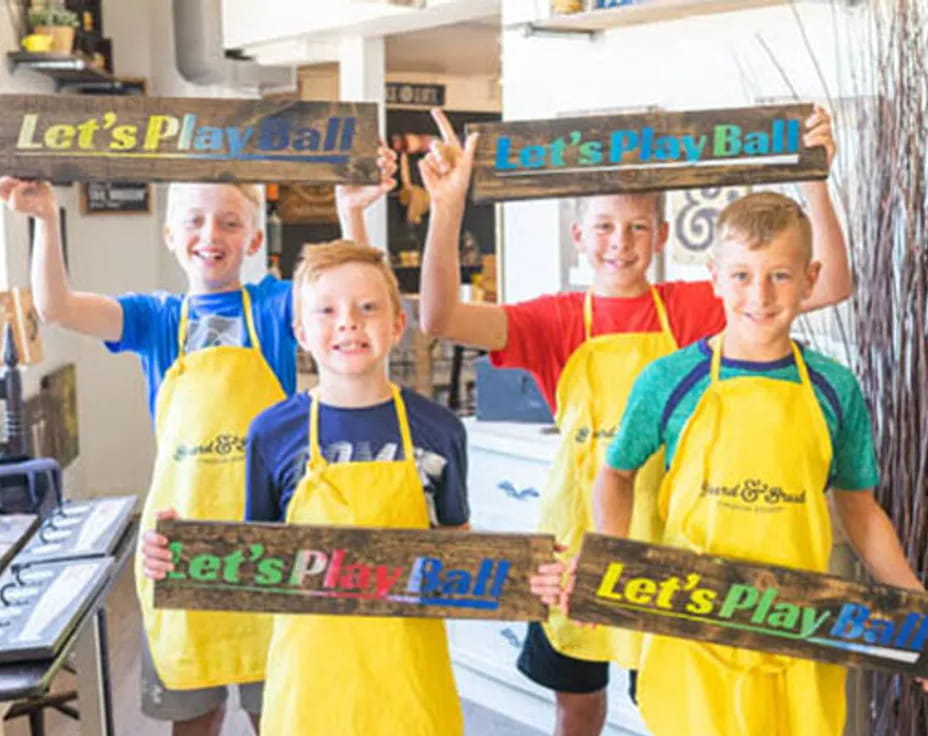 a group of boys holding up a sign