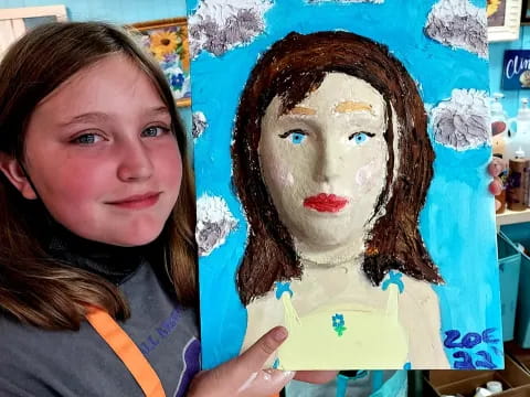 a woman holding a painting