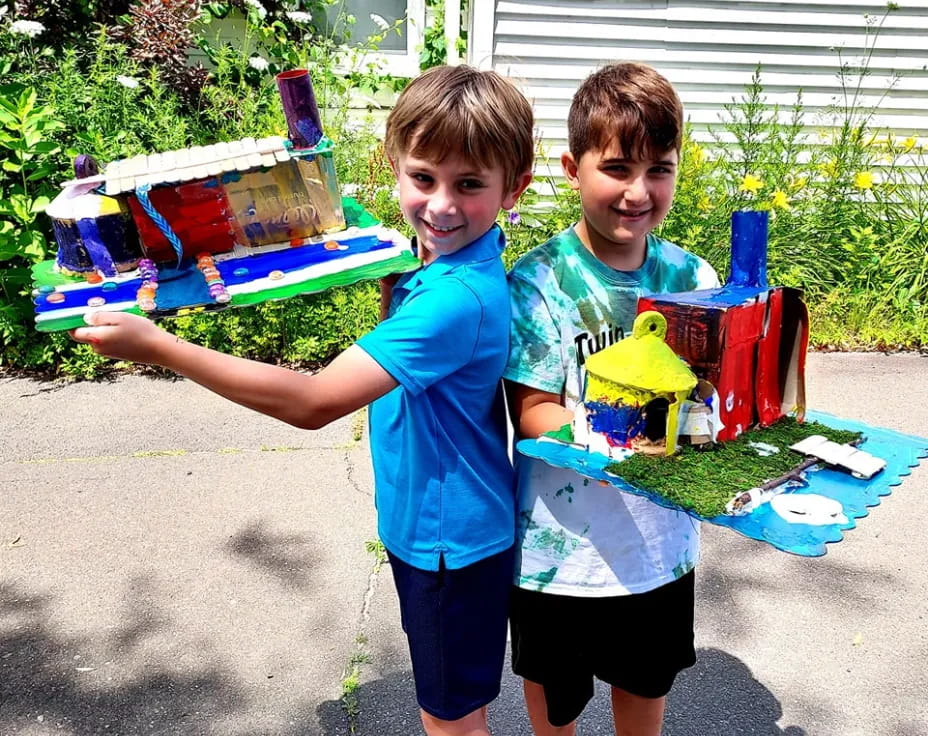two boys holding a toy