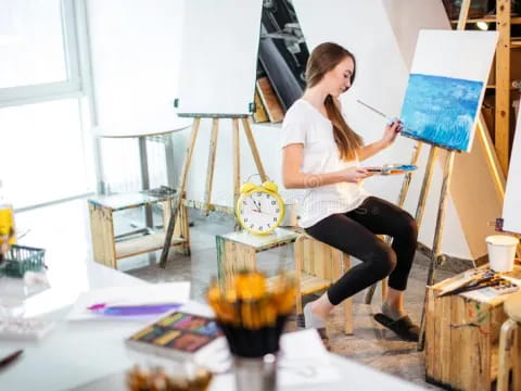 a person painting on a easel