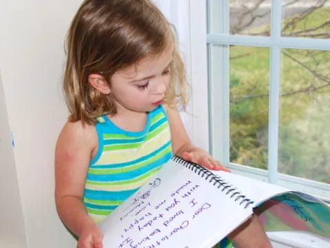 a girl holding a piece of paper