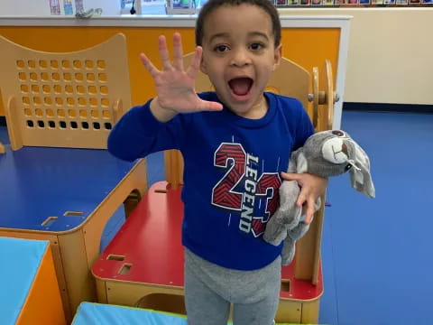 a boy holding a stuffed animal