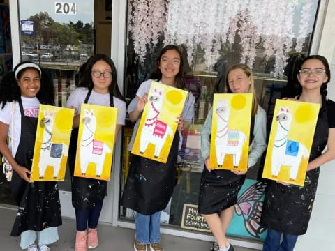 a group of girls holding signs
