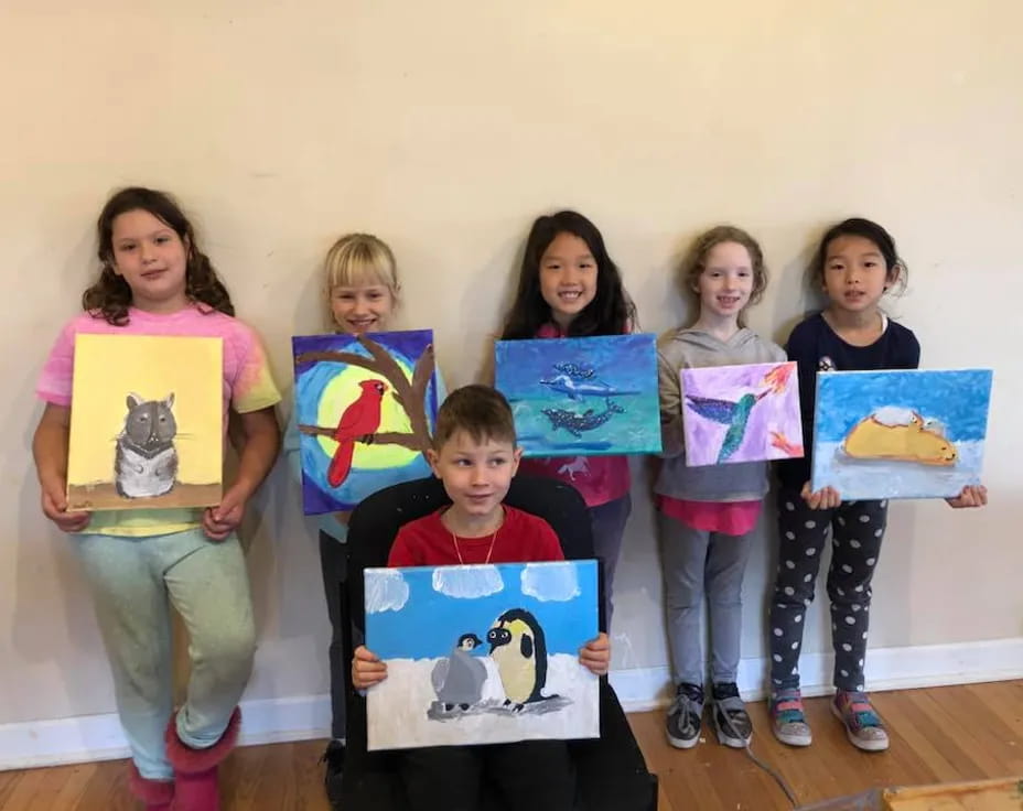 a group of children holding up posters