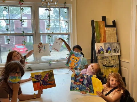 a group of people sitting at a table with toys