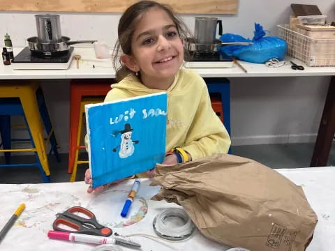 a girl holding a blue laptop