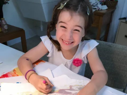 a girl sitting at a table