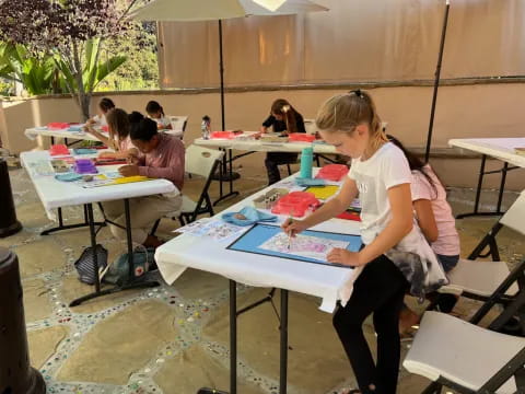 a man painting on a table