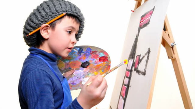 a young boy painting