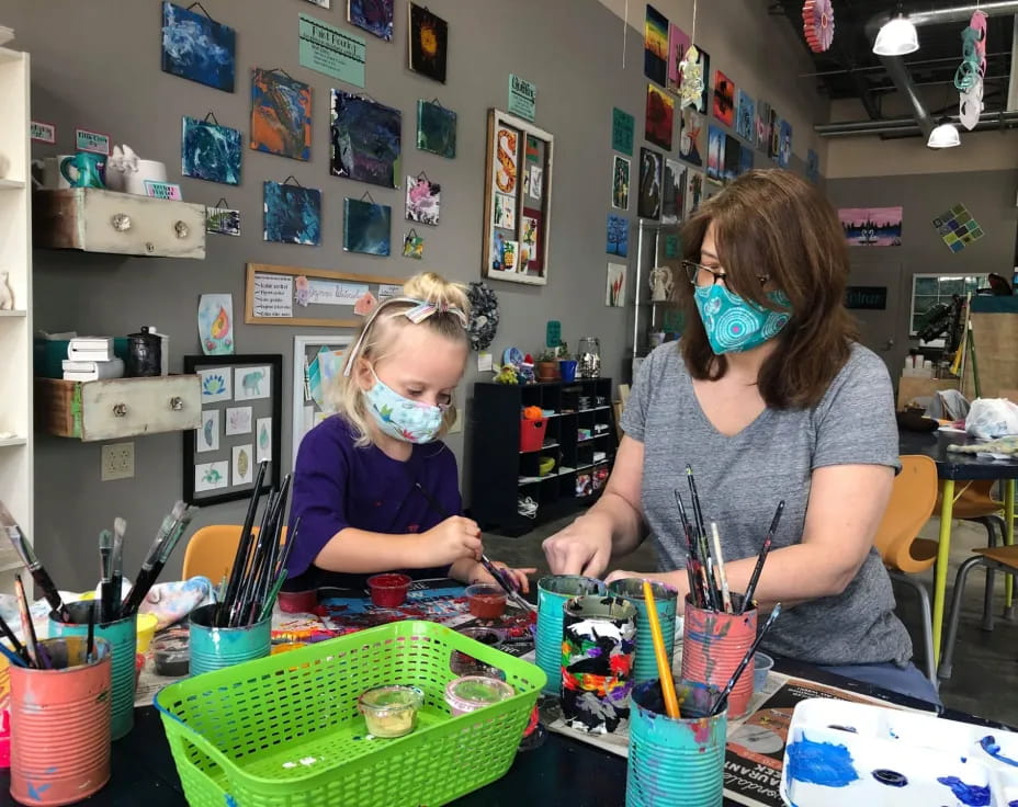 a person and a child wearing masks