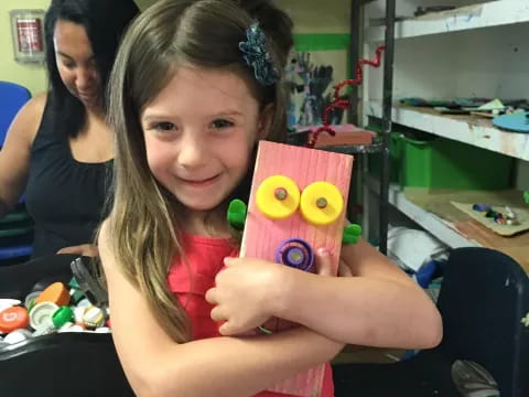 a girl holding a stuffed animal