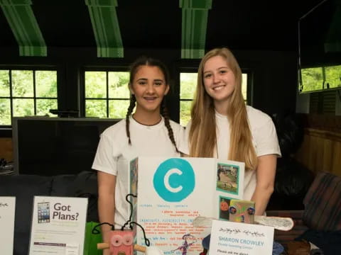 two women holding a sign