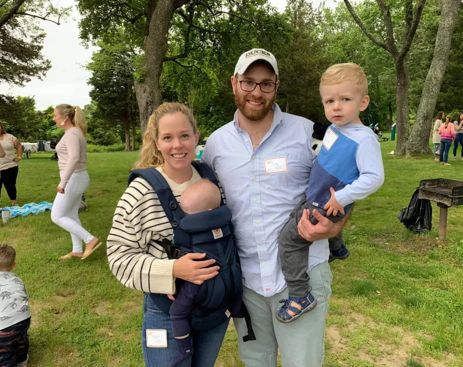 a man and woman holding a baby
