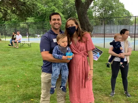 a man and woman holding a child