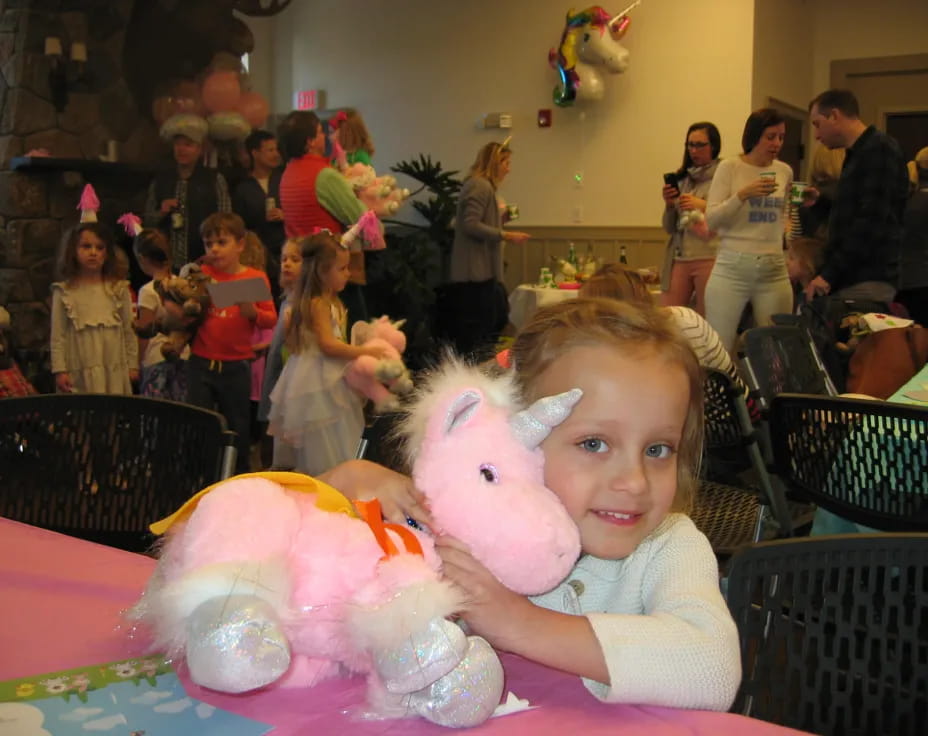 a girl holding a stuffed animal