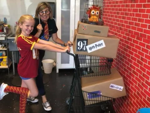 a couple of girls holding a box