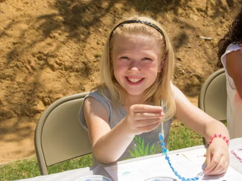 a girl sitting at a table