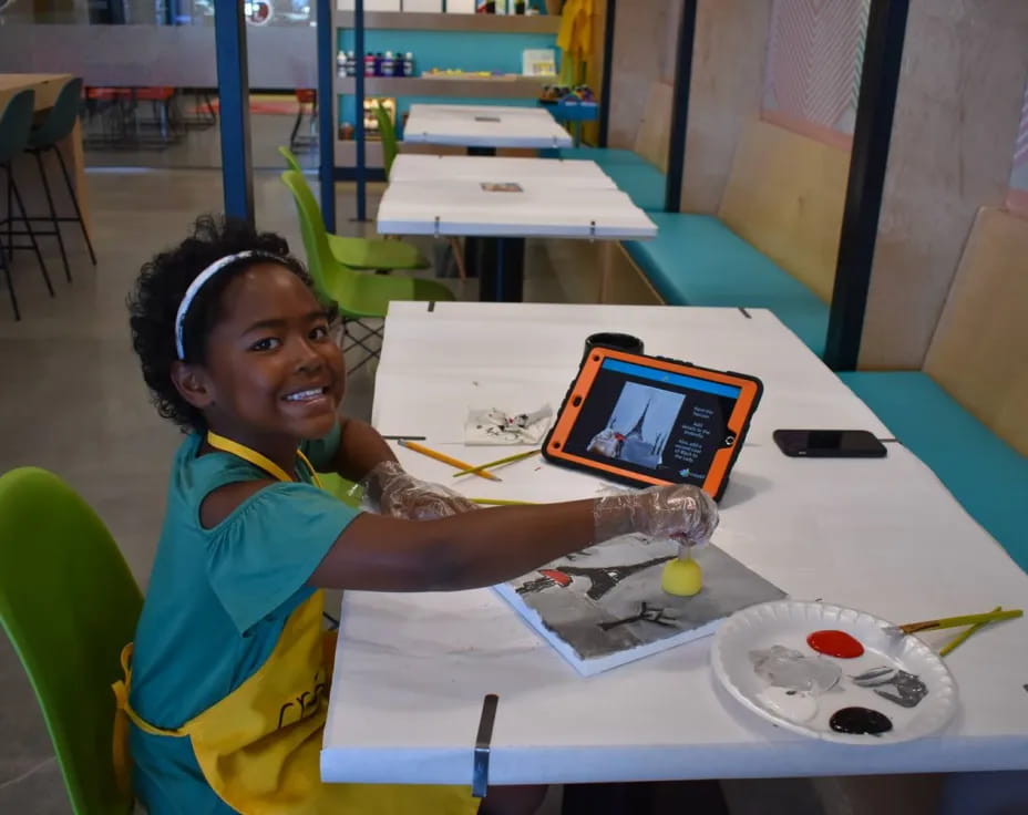 a girl sitting at a table