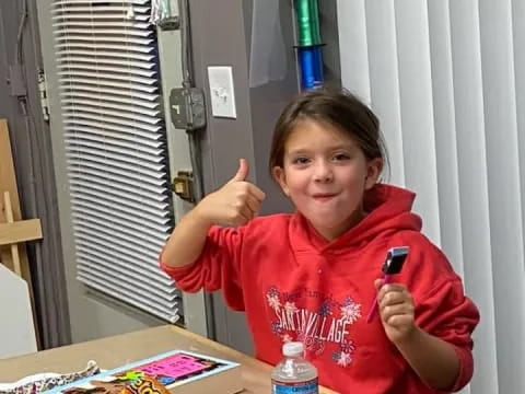 a girl sitting at a table