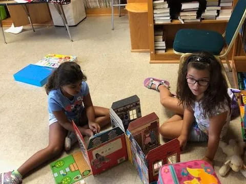 a couple of girls playing with toys