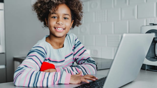 a young girl using a laptop