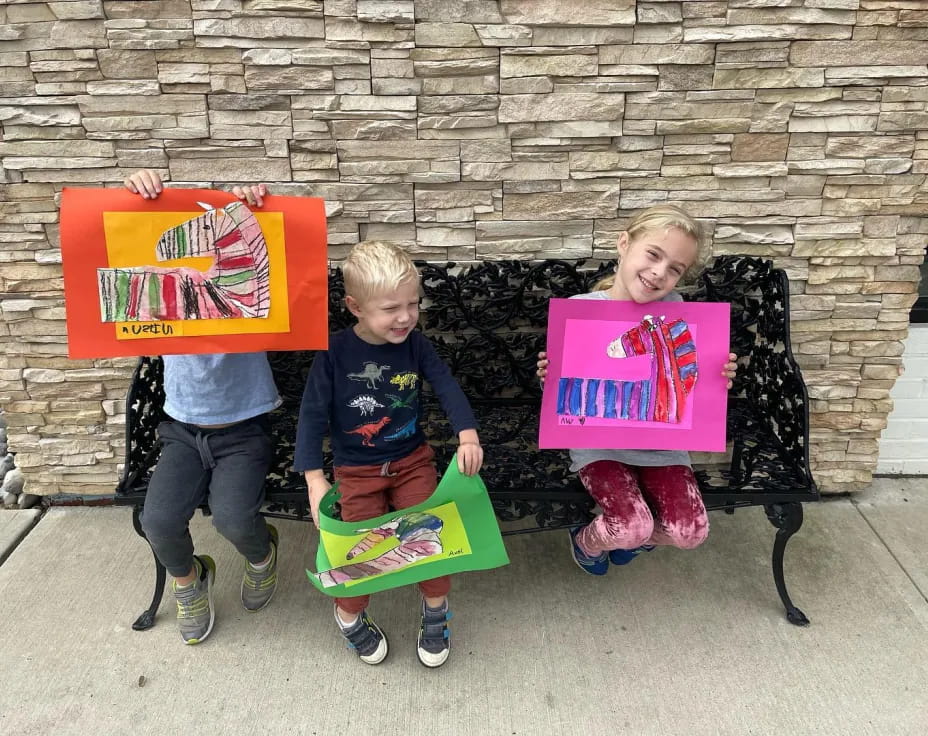 a couple of children holding signs