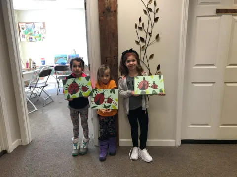 a group of girls holding signs