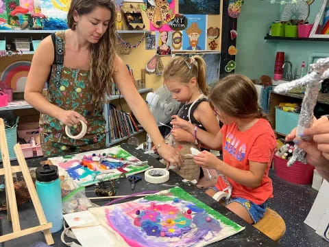 a person and children painting