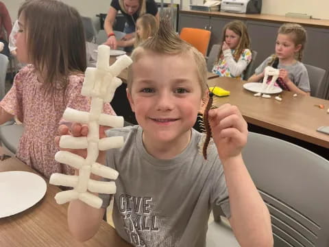 a boy holding a paper airplane