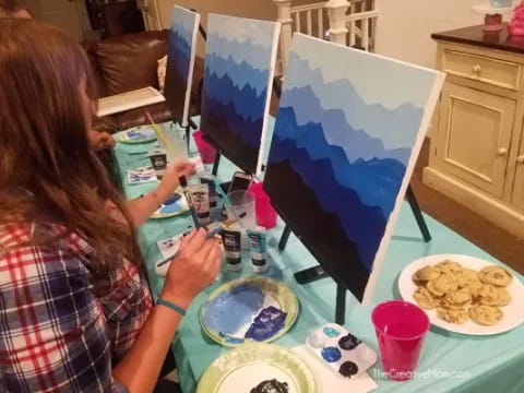 a girl painting on a table