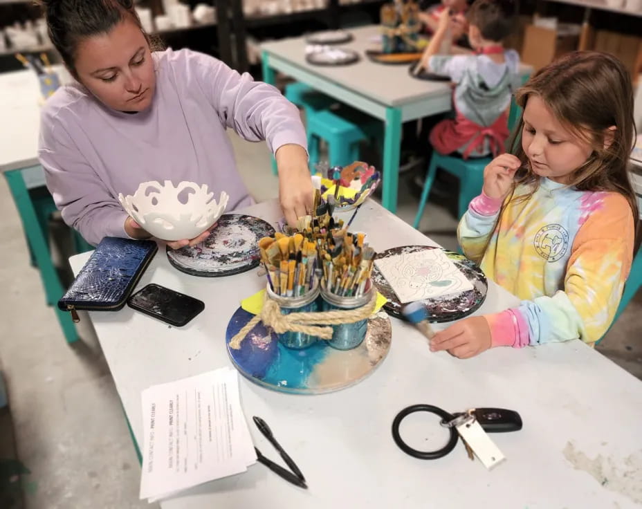 a person and a girl painting