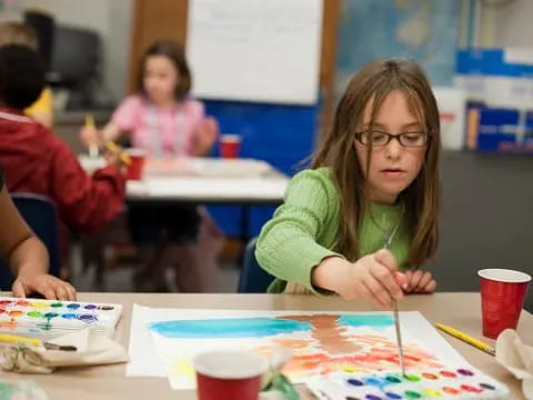 a girl sitting at a table