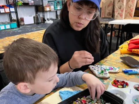 a woman and a boy playing with toys