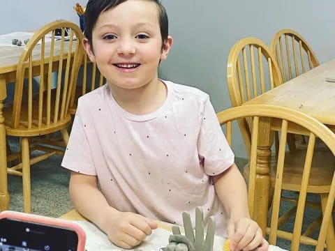a boy sitting at a table