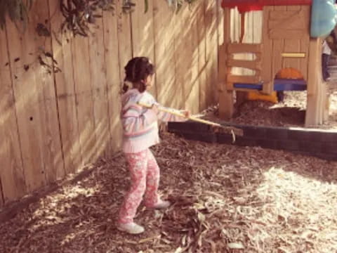 a girl holding a stick