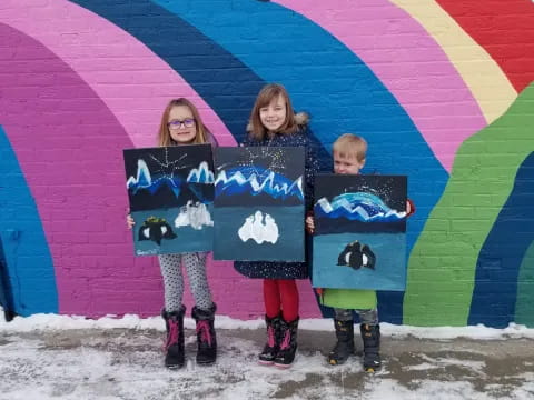 a group of girls holding signs
