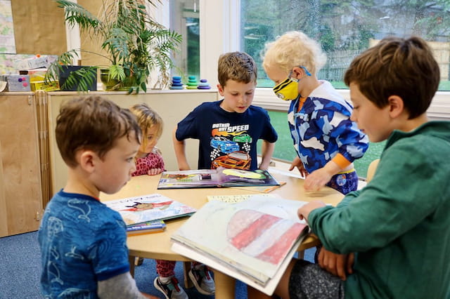 a group of children sitting around a table