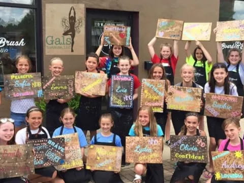 a group of children holding signs