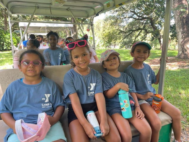 a group of kids sitting on a bench