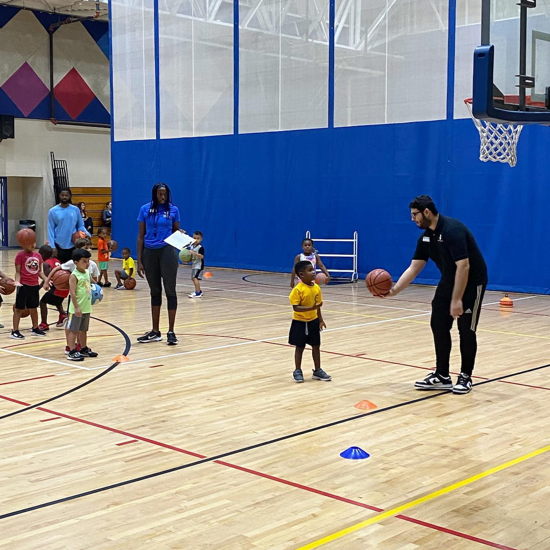 a group of people playing basketball