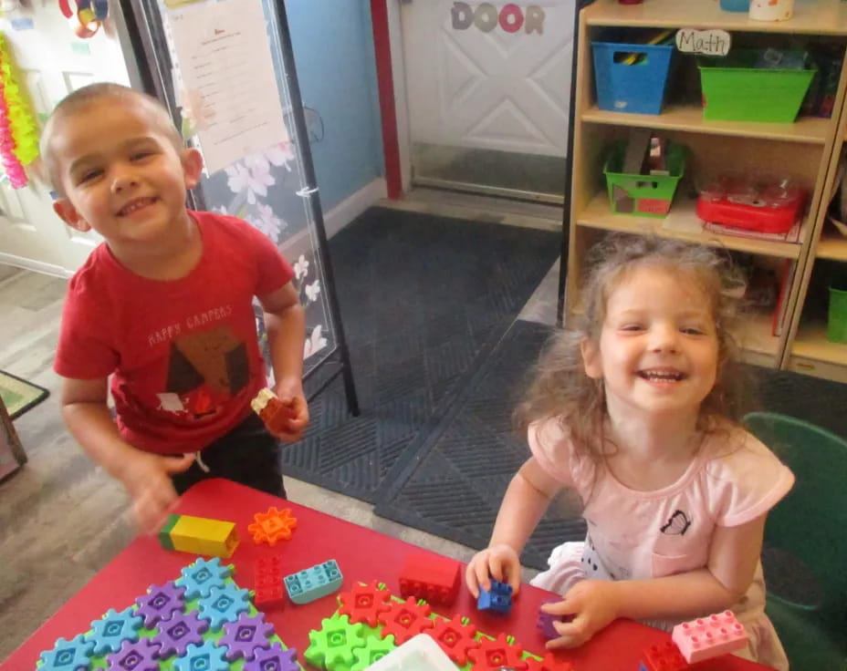 a boy and girl playing with toys